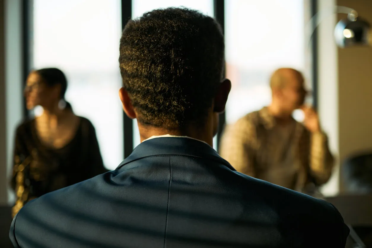 A man in a business meeting reading the room.